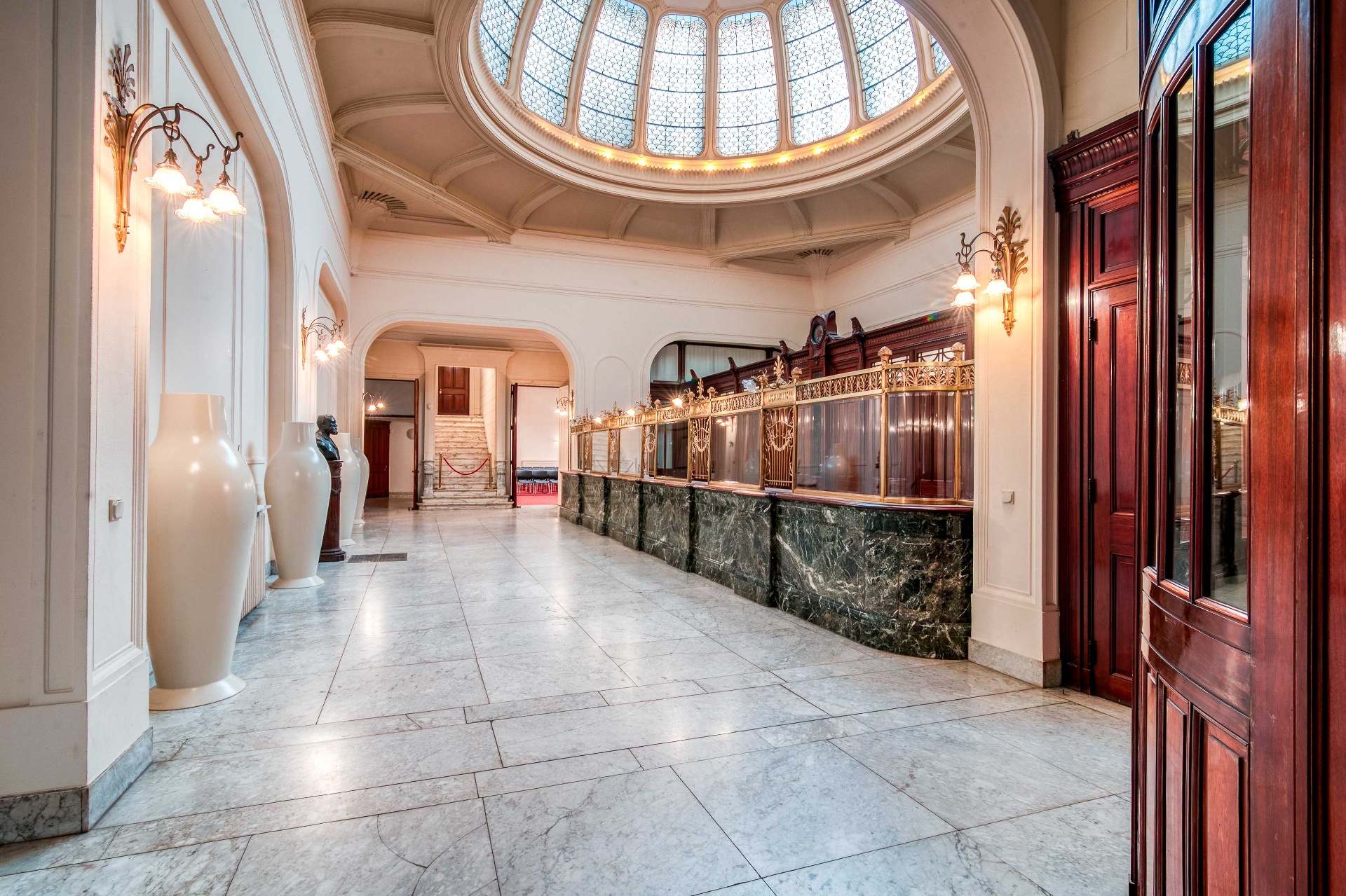 Marble entrance hall with historic banking counter and glass dome